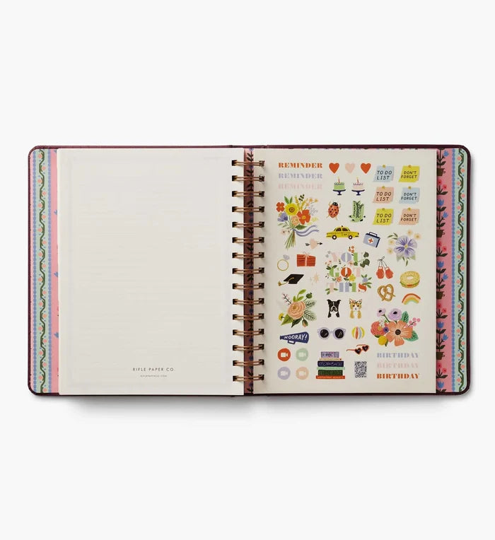 Open planner with colorful stickers on a white background