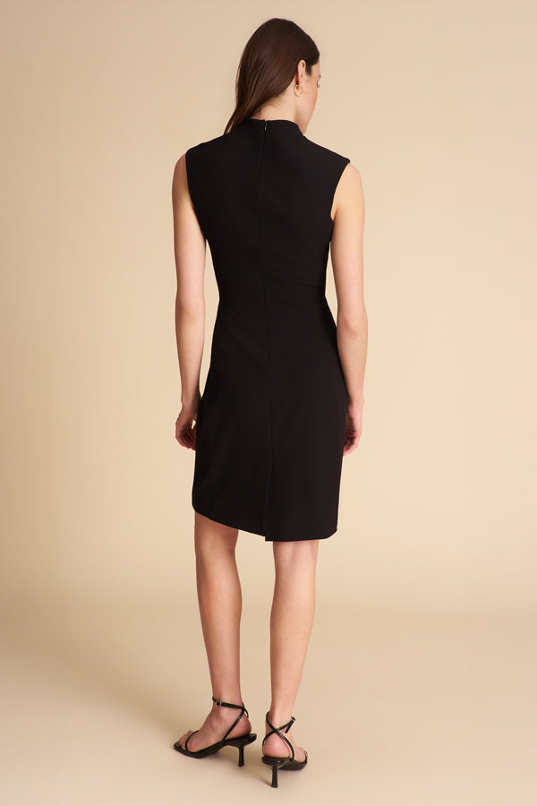 Woman wearing a black sleeveless dress on a beige background | Exclude | Grid Hover