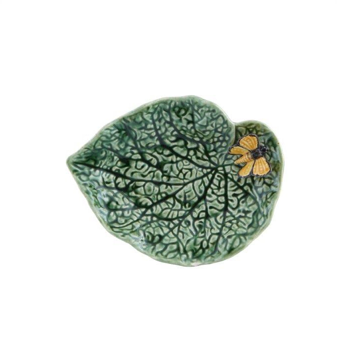 Ceramic leaf-shaped dish with a butterfly design on a white background