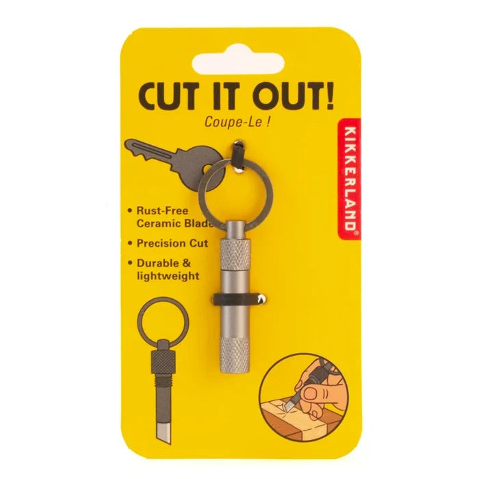 Kikkerland Cut It Out! rust-free ceramic blade key cutter tool in its original yellow blister packaging, featuring a silver and black metal keyring and blade.