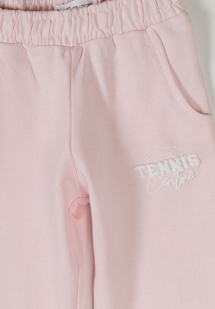 Detail of light pink joggers with elasticated waistband and side pockets.