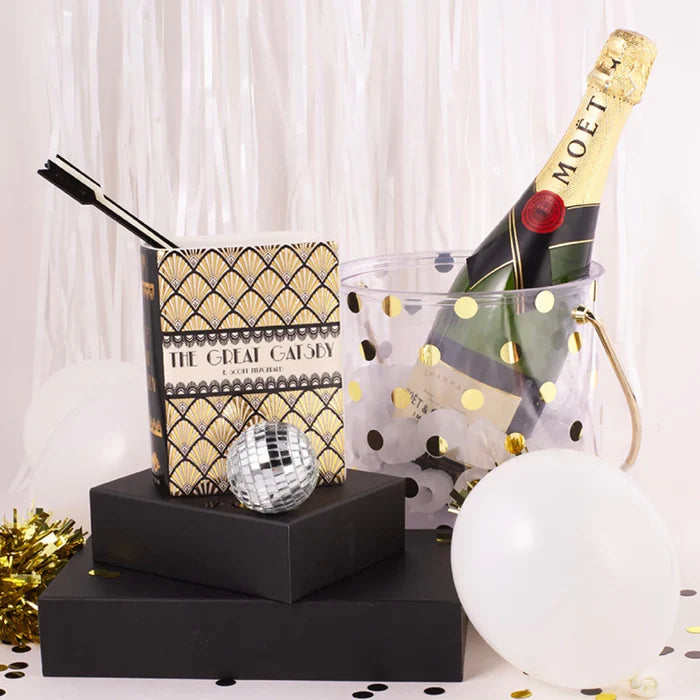 Photo shows vase shaped like a book in a party setting.