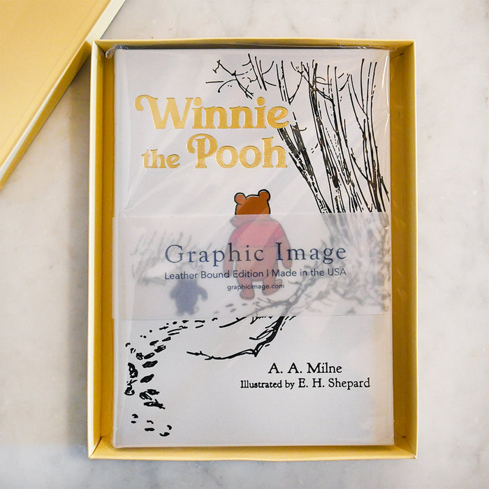 Winnie the Pooh book in a yellow box on a marble surface