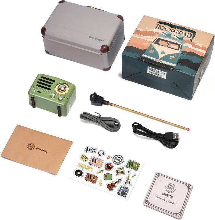 Collection of items including a small green radio, packaging box, and accessories on a white background