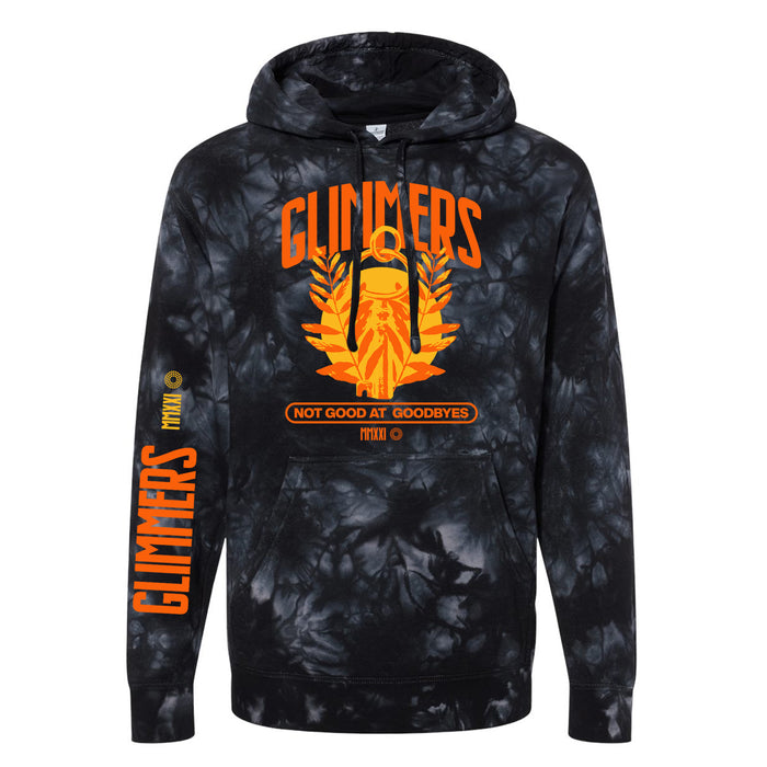 A black and gray tie-dye glimmers hoodie with a bold orange lantern and leaves graphic, GLIMMERS above, NOT GOOD AT GOODBYES below, and GLIMMERS printed vertically on the left sleeve.