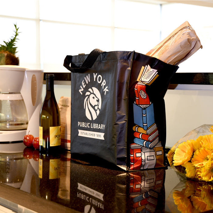 A black reusable tote bag placed in a kitchen setting.