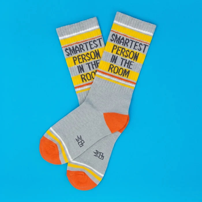 Gray socks with 'Smartest Person in the Room' text on a blue background