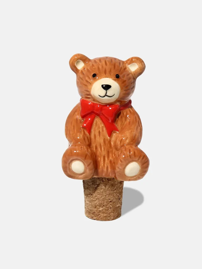 Bear-shaped bottle stopper with a red bow tie on a white background