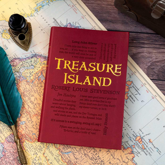 Red book titled 'Treasure Island' by Robert Louis Stevenson on a map with a quill pen.