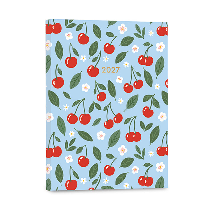A 2027 planner with a light blue cover decorated with a repeating pattern of red cherries, green leaves, and small white flowers, with the year '2027' printed in gold near the top center.