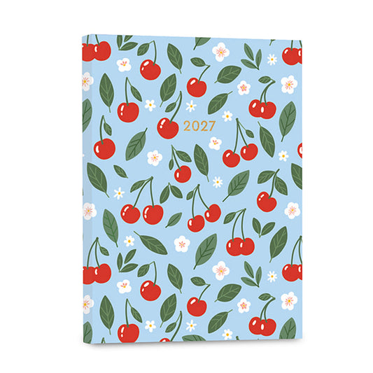 A 2027 planner with a light blue cover decorated with a repeating pattern of red cherries, green leaves, and small white flowers, with the year '2027' printed in gold near the top center.