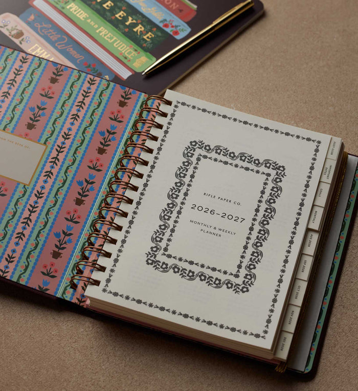 Planner with decorative cover and visible text on a brown surface
