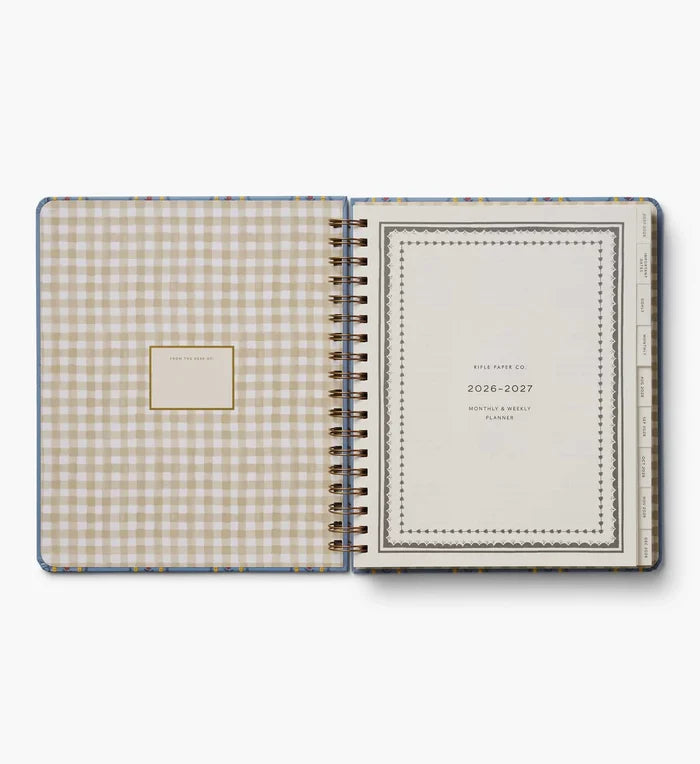 Open planner with gingham cover and text on a white background