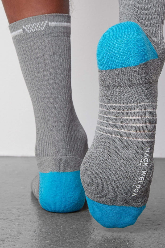 Back view of a man wearing AIRKNITx Crew Sock in Grey Heather