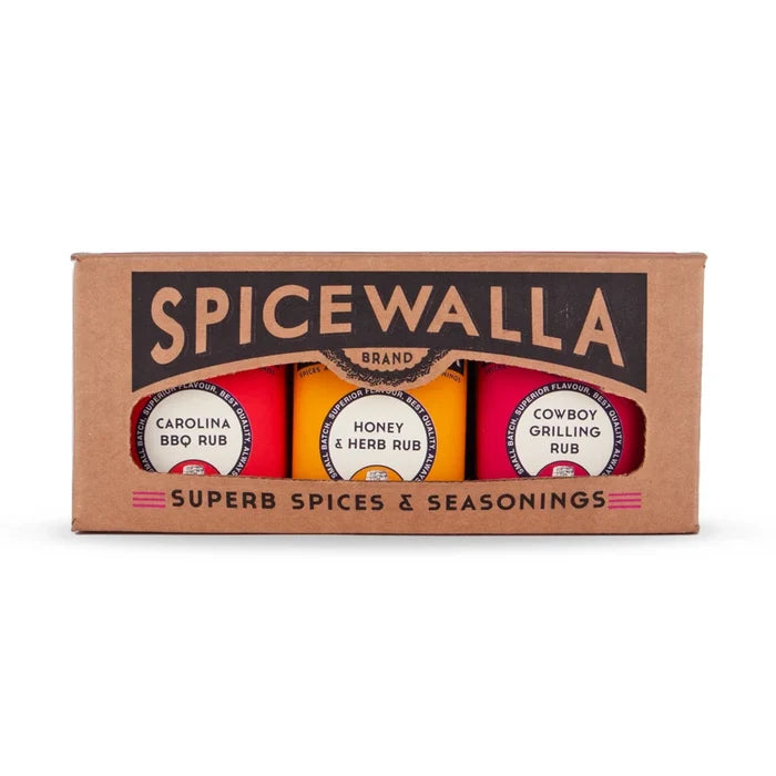 Spicewalla brand spice rub set in a brown cardboard box, containing three round seasoning rubs labeled Carolina Bro Rub, Honey & Herb Rub, and Cowboy Grilling Rub.