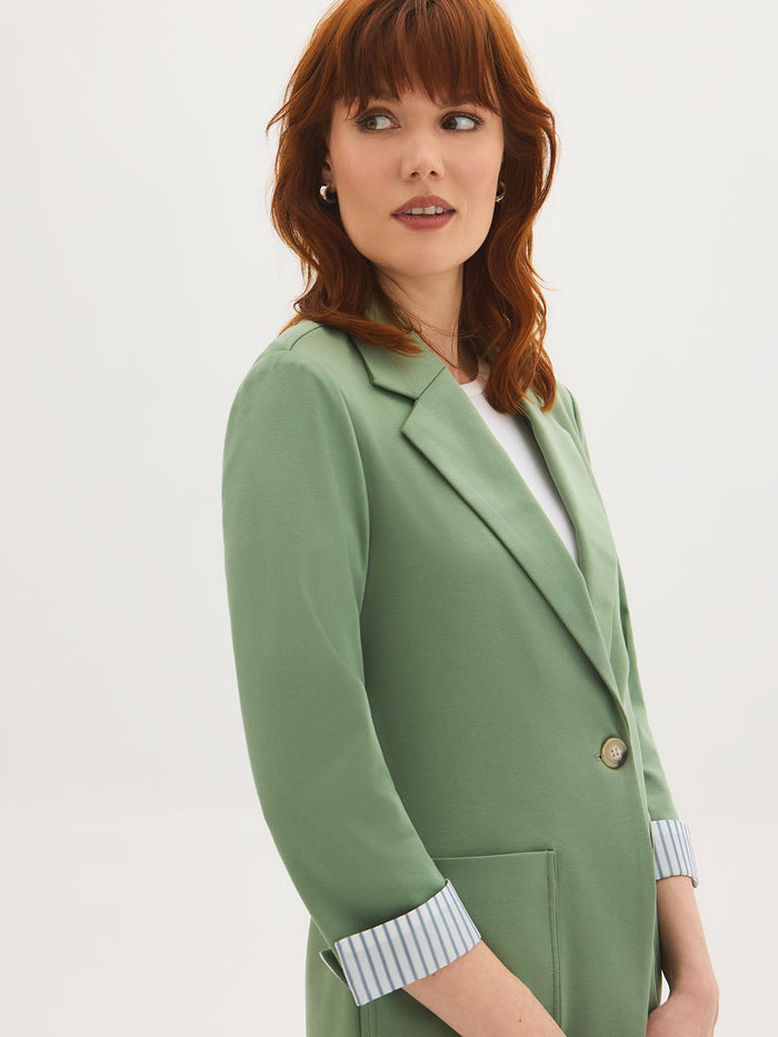 Lilac knit blazer with 3/4 sleeves and striped cuff lining, featuring patch pockets by Le Chateau.