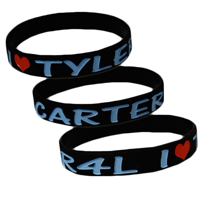 Three black silicone wristbands by Tyler Carter, featuring I ♥ TYLER CARTER in blue with a red heart, stacked on a white background—perfect for dedicated fans.