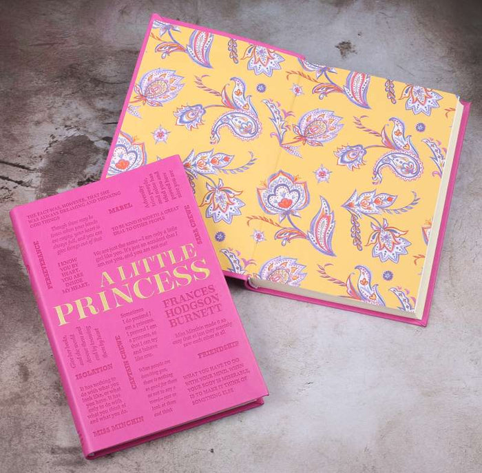 Pink book titled 'A Little Princess' with a yellow patterned cover on a concrete surface
