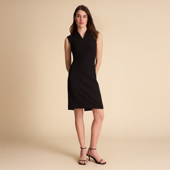 Woman wearing a black sleeveless dress on a beige background | Lead