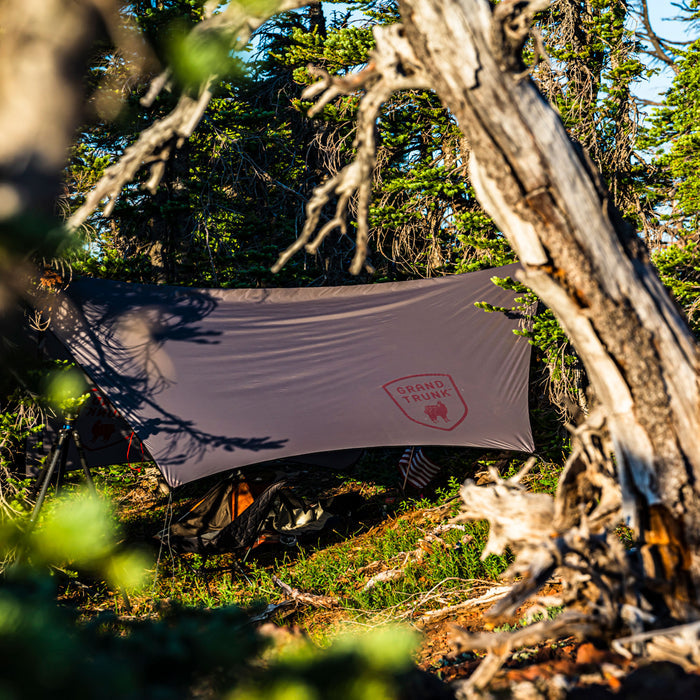 air bivvy all weather shelter set up in forest keeps bugs out while hammock camping