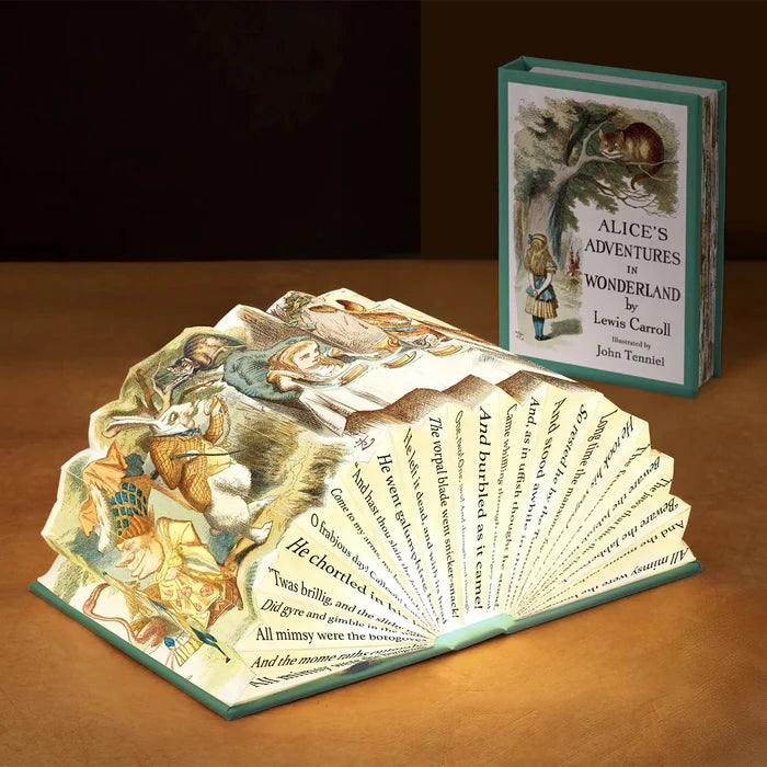 Pop-up book of 'Alice's Adventures in Wonderland' by Lewis Carroll on a wooden surface.