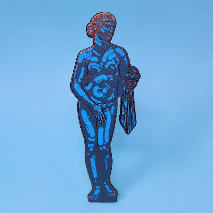 A leather bookmark shaped as the classical Aphrodite statue, rendered in dark navy blue with bright cyan-blue muscle and drapery highlights.