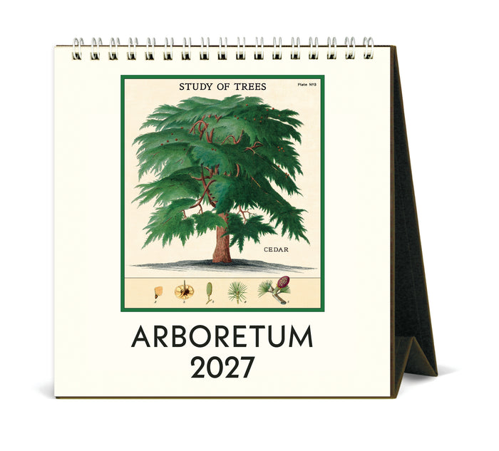 A spiral-bound 2027 desk calendar titled 'ARBORETUM 2027' with a vintage-style botanical illustration of a cedar tree on the front cover, shown standing on a white background.