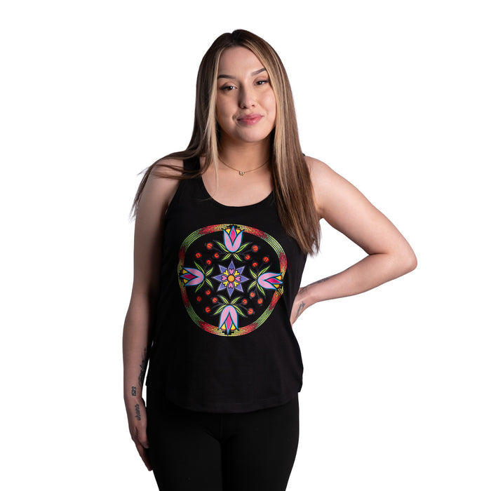 Woman wearing a black tank top with a colorful floral design on a white background