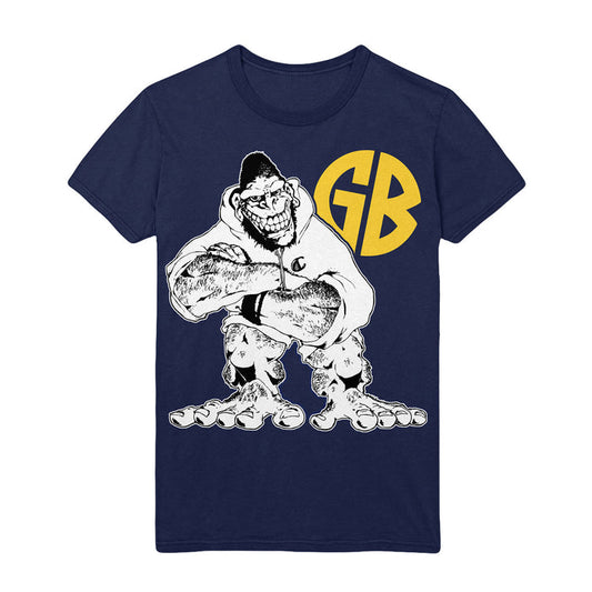 Navy blue Gorilla Biscuits t-shirt with a cartoon muscular character in a hoodie and cap, arms crossed, grinning. Large yellow “GB” letters appear behind the figure.
