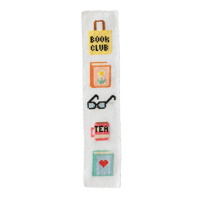 Cross-stitched bookmark with various symbols on a white background