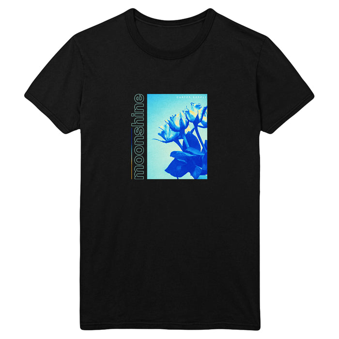 Black t-shirt by Tyler Carter featuring a blue-toned floral image with moonshine vertically on the left and CARTEL MAORI in small text at the top right of the image.