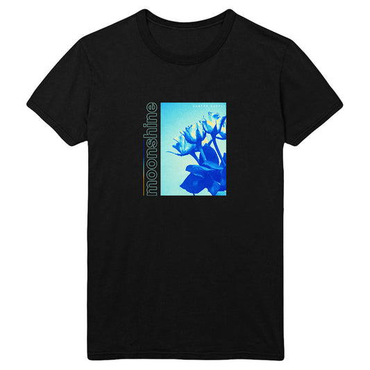 Black t-shirt by Tyler Carter featuring a blue-toned floral image with moonshine vertically on the left and CARTEL MAORI in small text at the top right of the image.