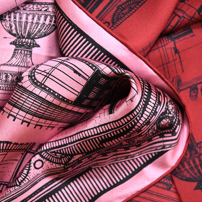 Close-up of the double-sided red and pink silk fabric with black architectural drawings of NYPL's flagship building.