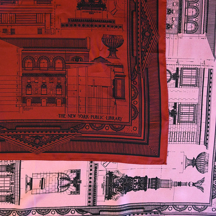 Close-up of the double-sided red and pink with black architectural drawings of NYPL's flagship building. Text reads: The New York Public Library.