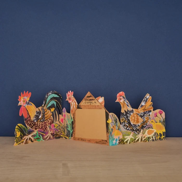 The reverse side of the opened three-panel die-cut card, featuring illustrated chickens and a central hen-house-shaped panel labeled "Message" with space to write.