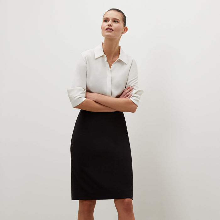 Front image of a woman standing wearing the cobble hill packable suiting in black | Exclude