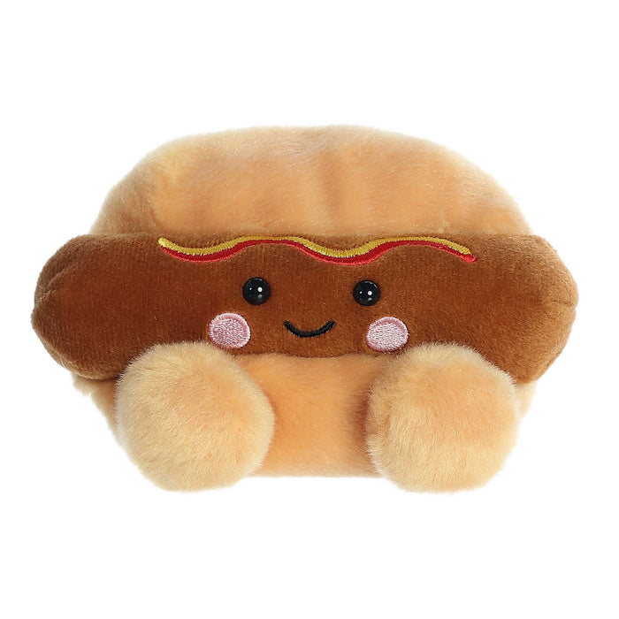 Plush toy shaped like a hot dog with a smiley face on a white background