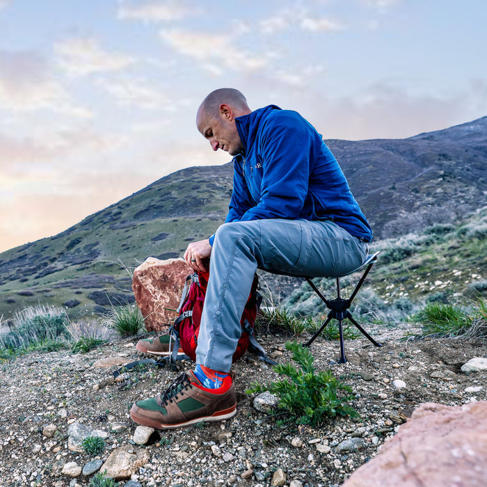 Man on stool n the mountains