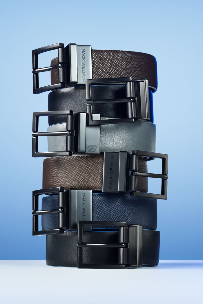 Stack of Covert Leather Belts showing each color variation with a blue background