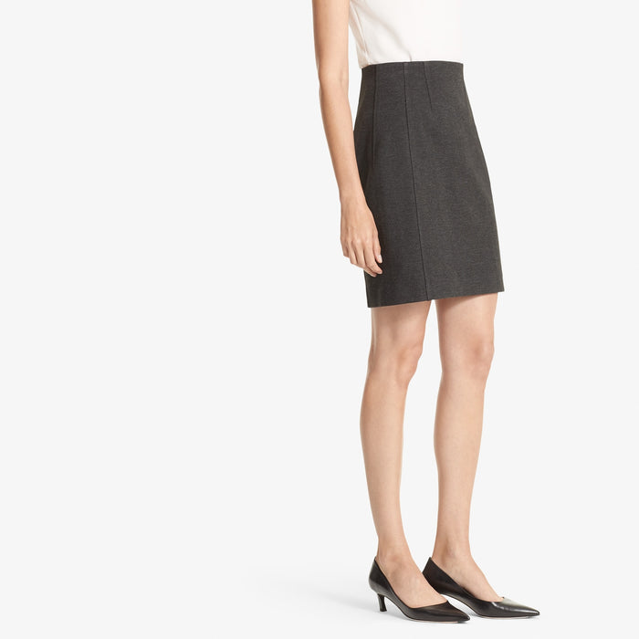 Side image of a woman standing wearing the Crosby skirt textured ponte in Charcoal