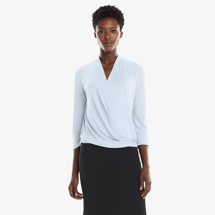 Front image of a woman standing wearing the Deneuve top in Oxford Blue | Lead