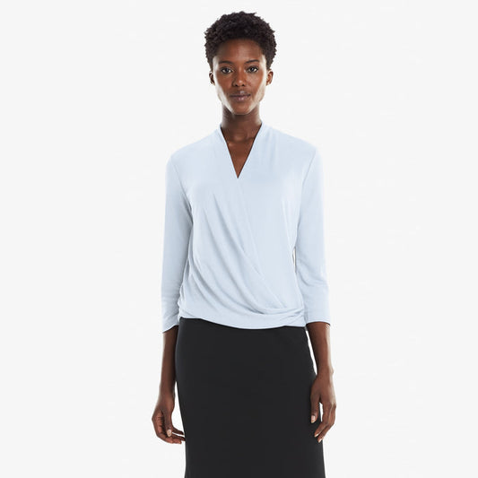 Front image of a woman standing wearing the Deneuve top in Oxford Blue | Lead