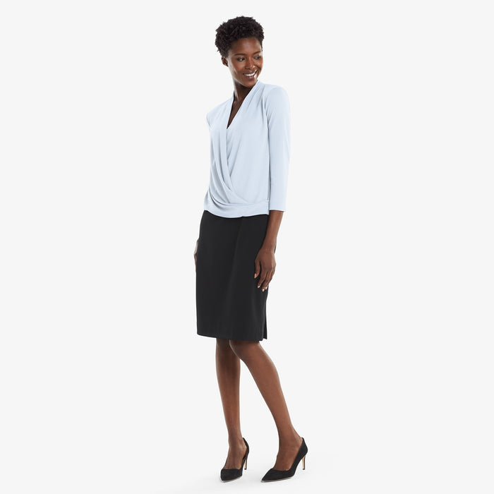 Front image of a woman standing wearing the Deneuve top in Oxford Blue