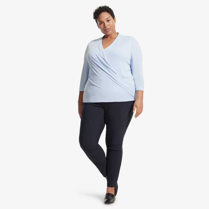 Front image of a woman standing wearing the Deneuve top in Oxford Blue