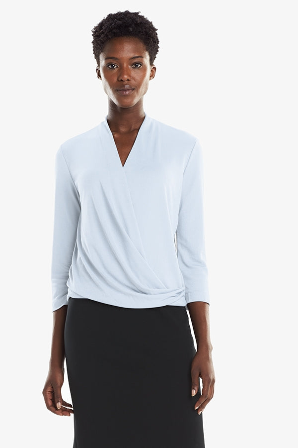Front image of a woman standing wearing the Deneuve top in Oxford Blue | Grid | Exclude