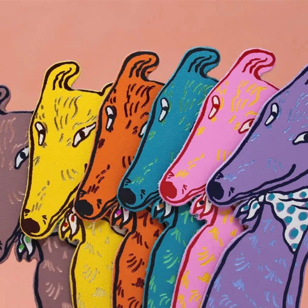 Five colorful bookmark dogs in a row on a pink background