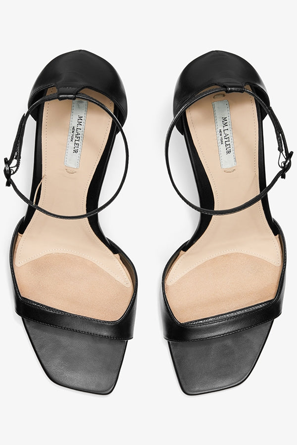 Packshot image of a woman standing wearing the Ella sandal in black | Grid Hover | Exclude