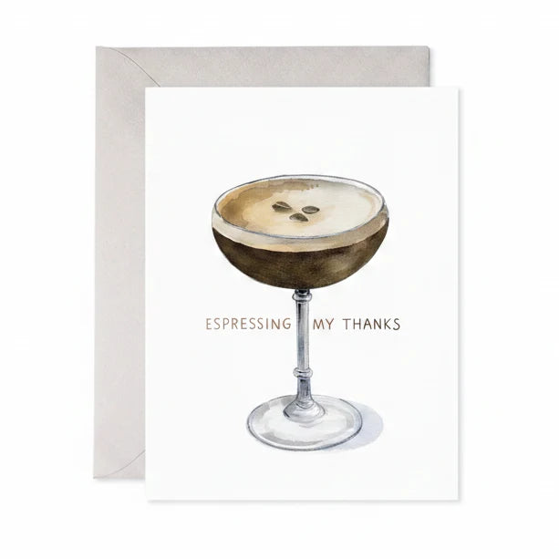 A greeting card with a white front featuring a watercolor illustration of an espresso martini in a coupe glass and the text 'ESPRESSO MY THANKS', shown with a light gray envelope behind it on a white background.