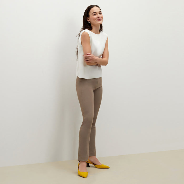 Side image of a woman standing wearing the foster pant in russet