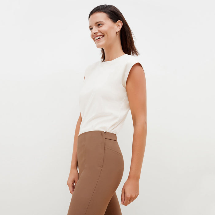 Side image of a woman standing wearing the Foster Pant—Everstretch in Saddle